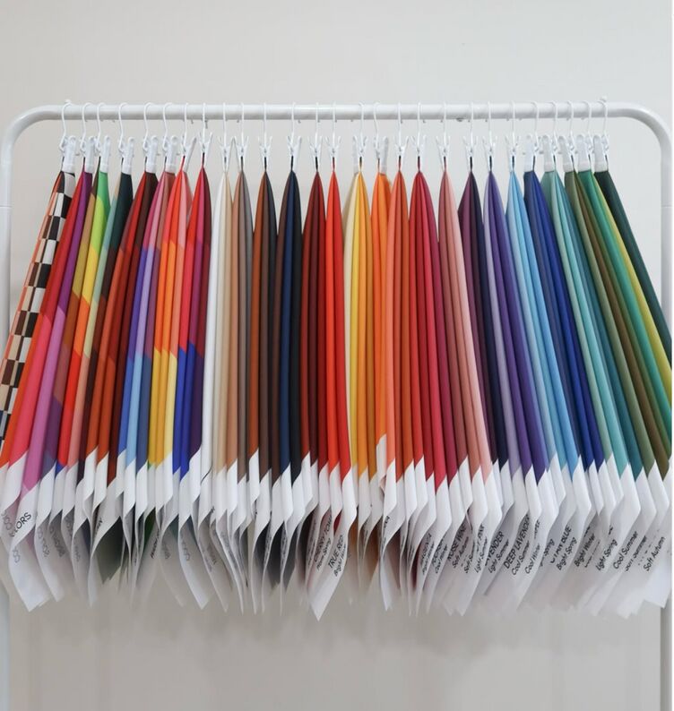 Color analysis drapes hanging on a white rack