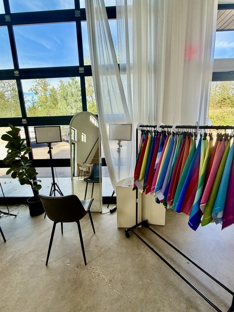 A color party setup with a draping chair, true-color lights, mirror and a full drape rack