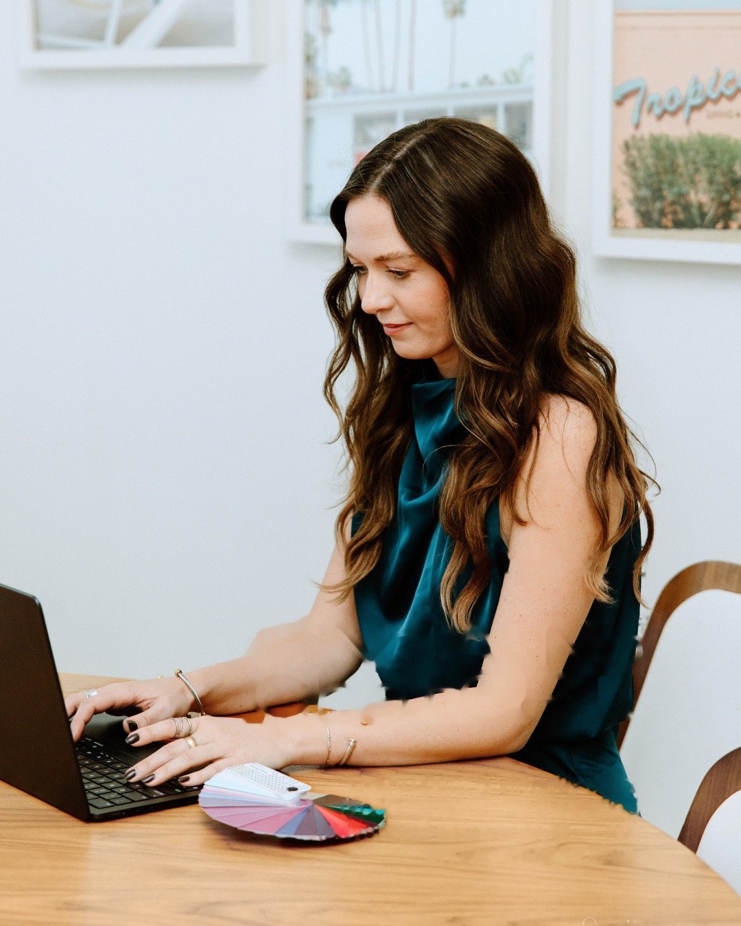 Nicole at her laptop with a swatch fan, completing a virtual color analysis by hand
